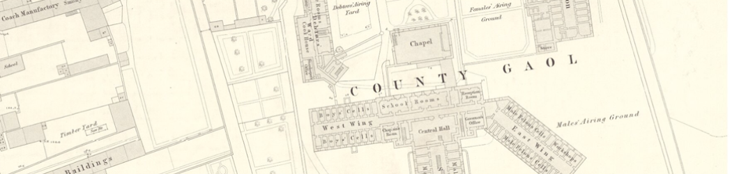 Zoomed in image of a 19th century map showing Durham Jail, made up of newly built structures with large exercise yards between them. Other buildings of the City of Durham can be seen outside the prison walls.