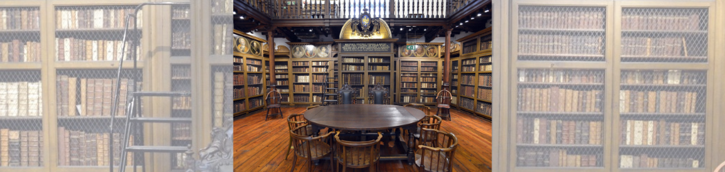 Cosin’s Library interior. A wooden table in front of large wooden bookcases filled with historic books.
